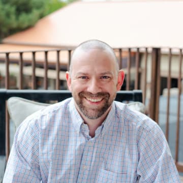 Headshot of Dustin Cole, a seasoned software architect.